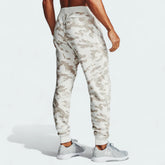 Under Armour Rival Fleece Camo Track Pants Men's in onyx white camo, back view showcasing the tapered leg design and elastic cuffs.